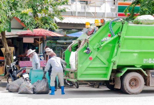 Team members discussing safety procedures next to skips