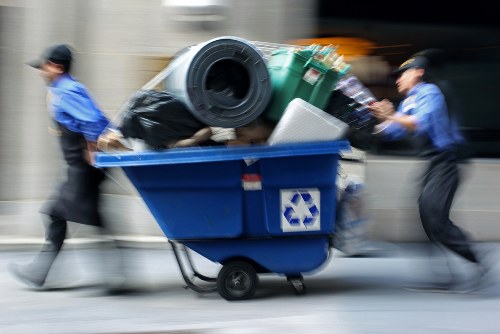 Operatives preparing a skip for collection showing safety gear and site checks